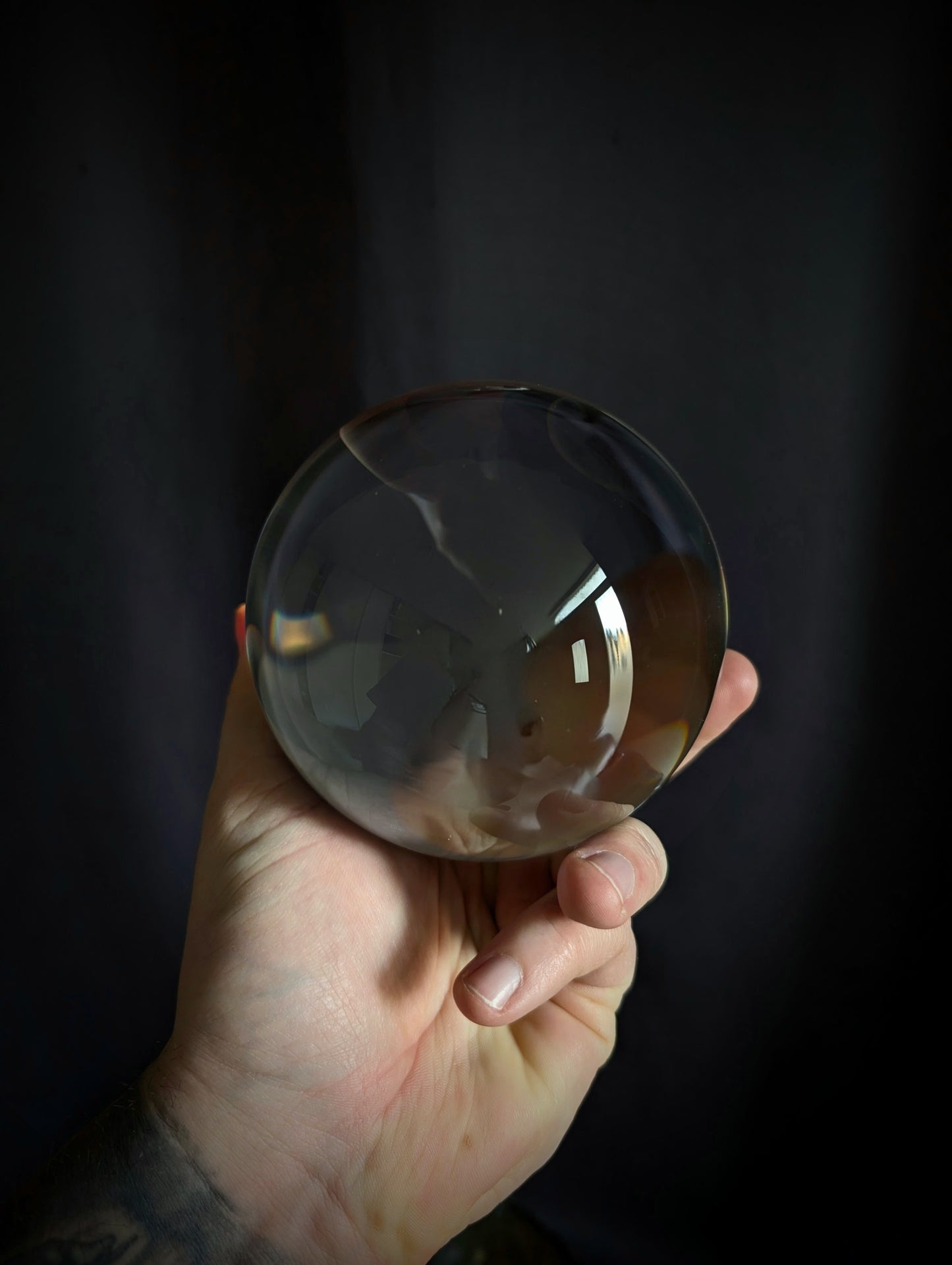 Crystal ball on a metal base with goat heads