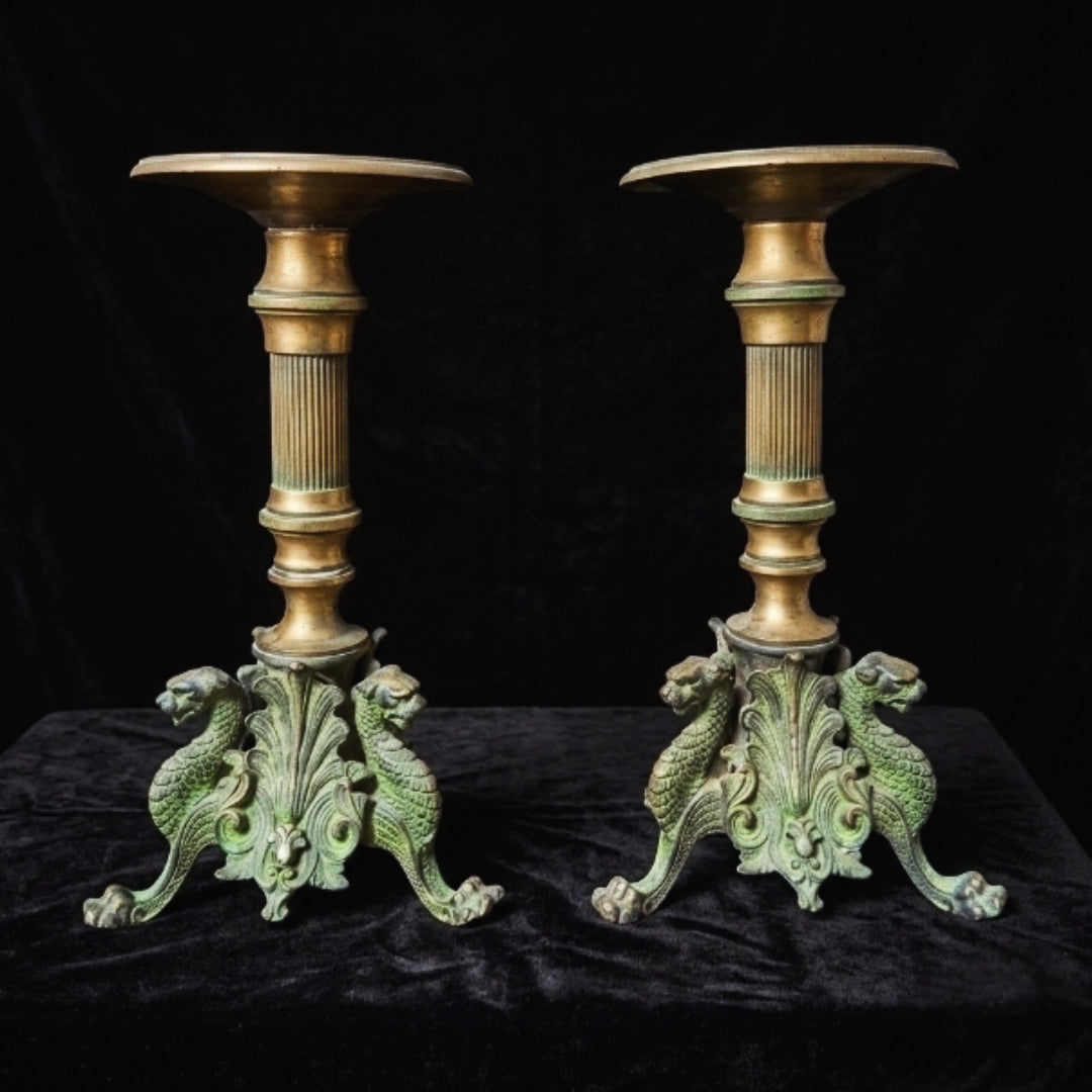 Antique metal candlestick with griffins
