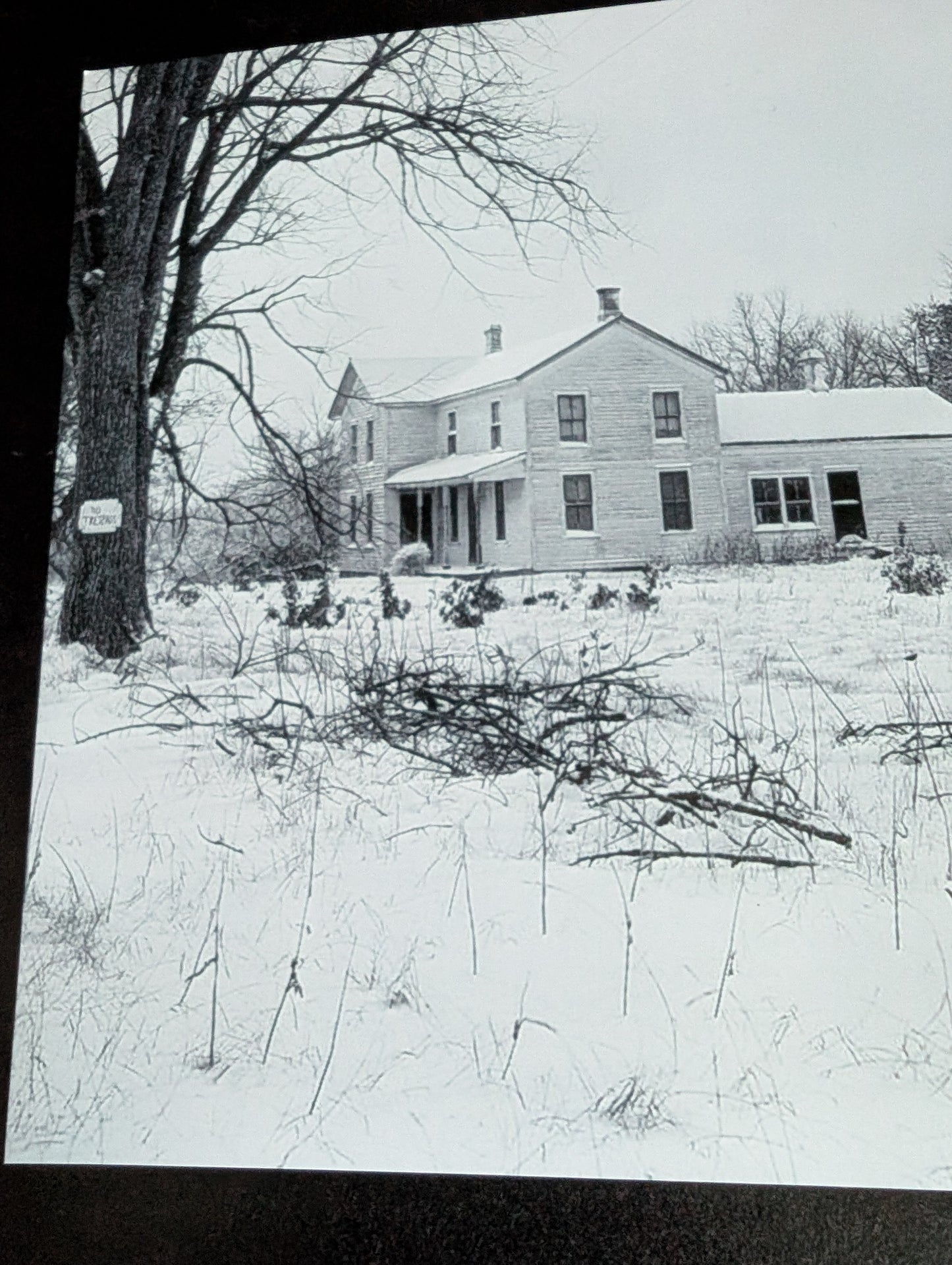 Piece of ED GEIN's infamous farm in a frame with photo