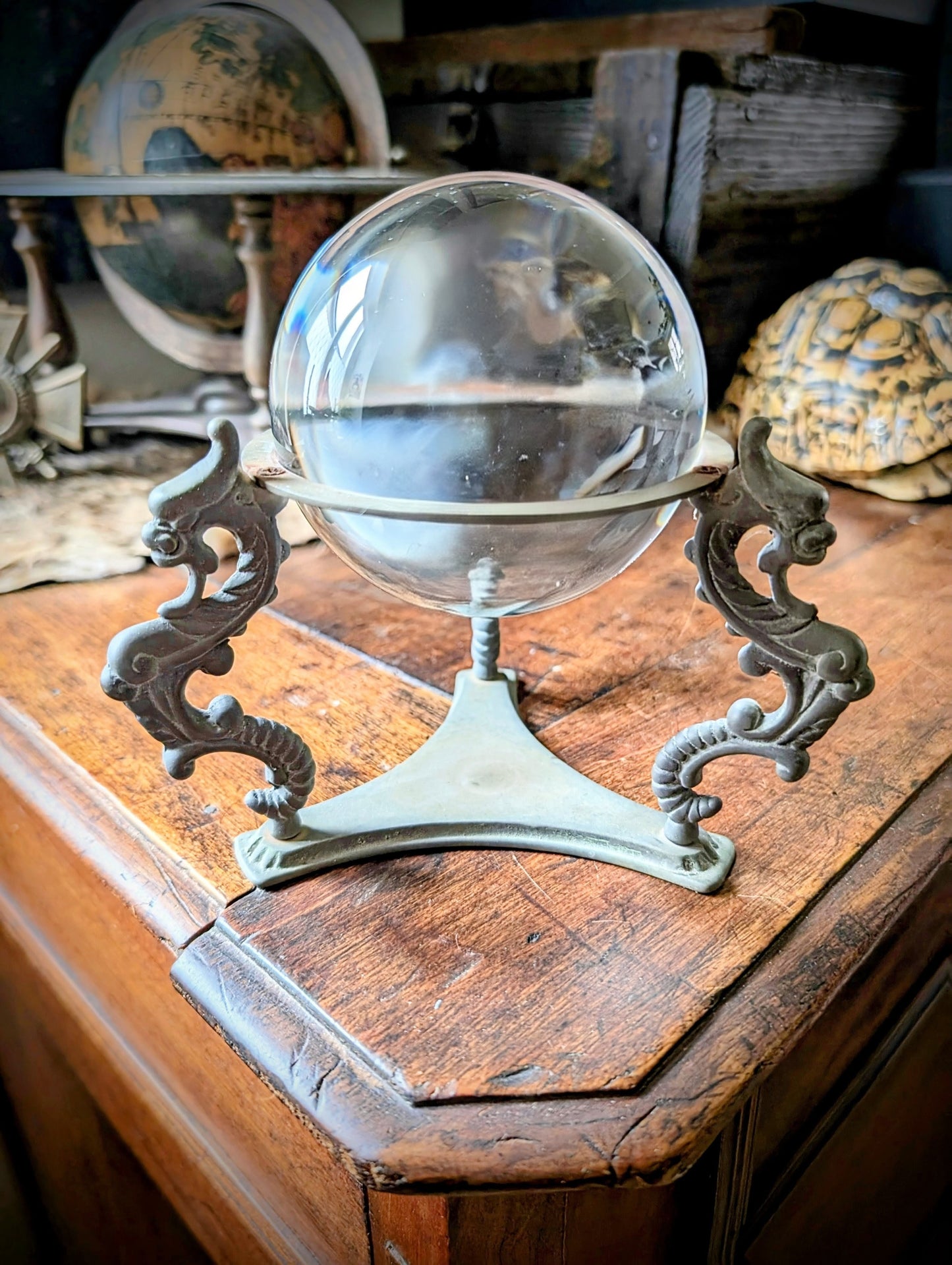 Vintage crystal ball with chimeras