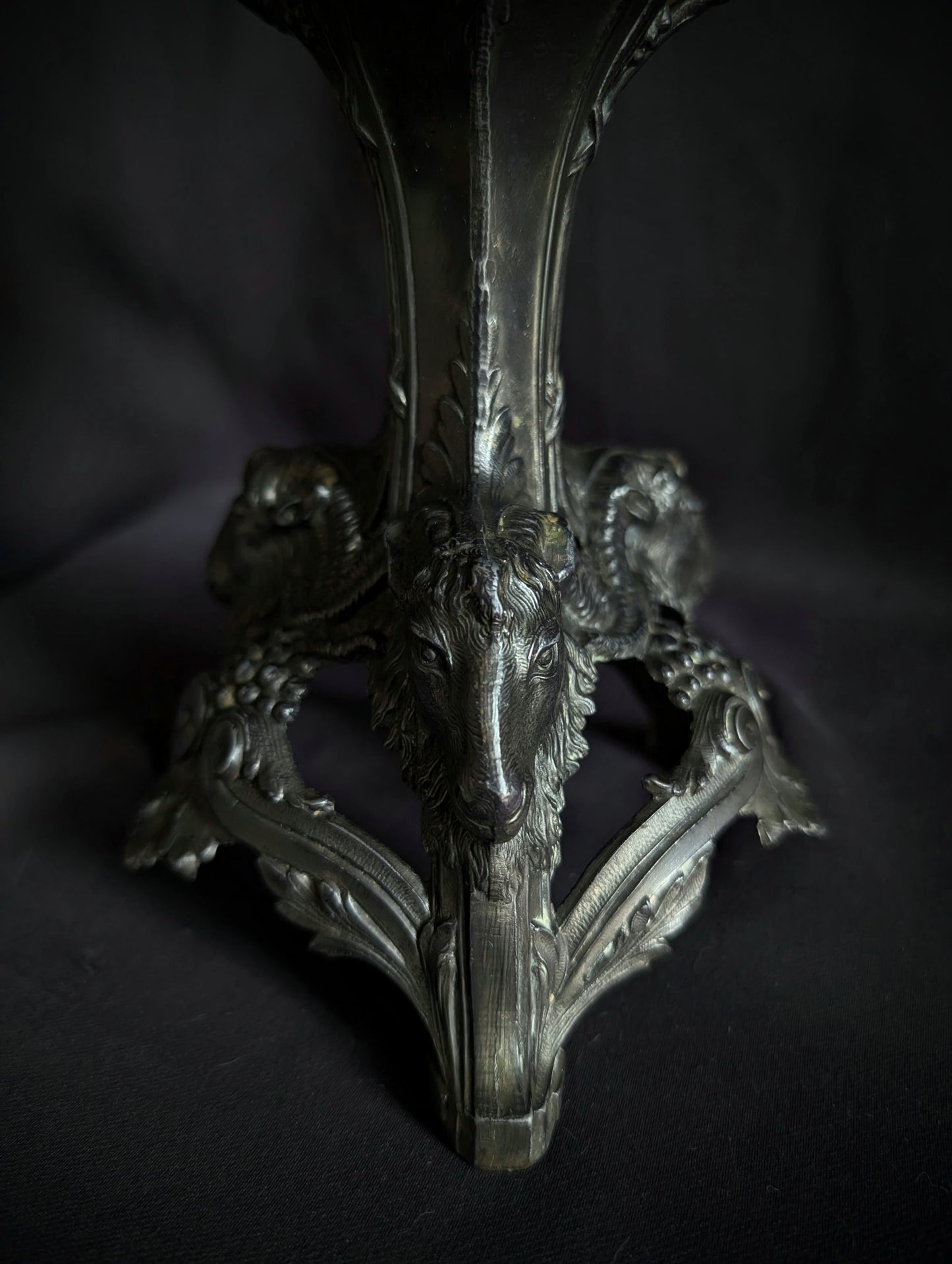 Crystal ball on a metal base with goat heads