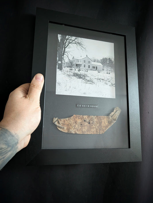 Piece of ED GEIN's infamous Plainfield farm  in a frame with photo